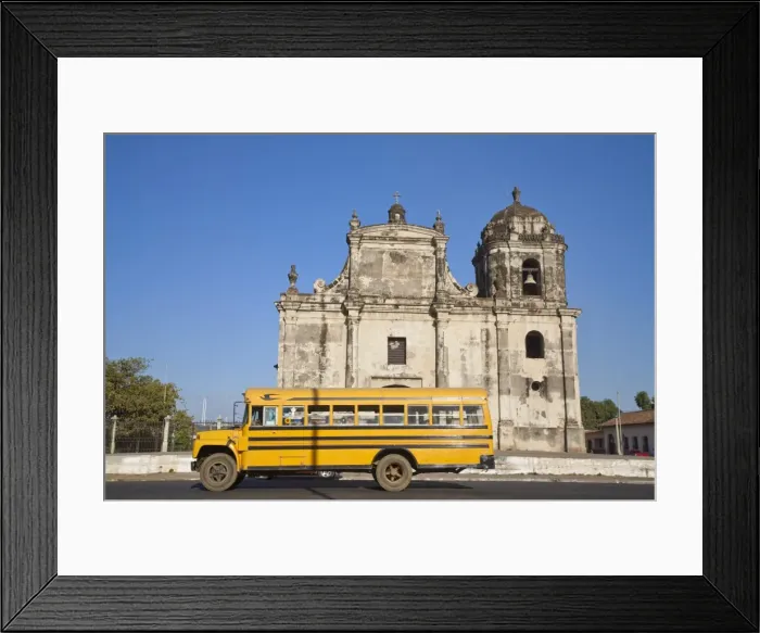 Framed Print : Nicaragua, Leon, American yellow bluebird bus driving past San Juan Church Framed Print : Nicaragua, Leon, American yellow bluebird bus driving past San Juan Church