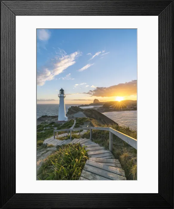 Framed Print : The sun is setting down behind Castle Rock and Castlepoint lighthouse. Castlepoint