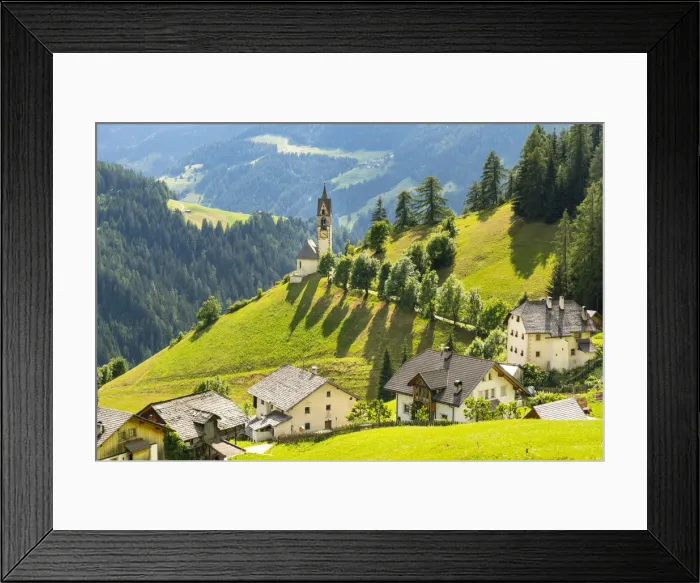 Framed Print : The church of La Val between threes and meadows in summer Framed Print : The church of La Val between threes and meadows in summer