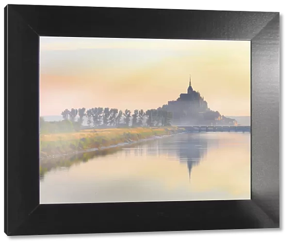 France, Normandy, Le Mont Saint Michel, shrouded in fog at dawn, reflected in river