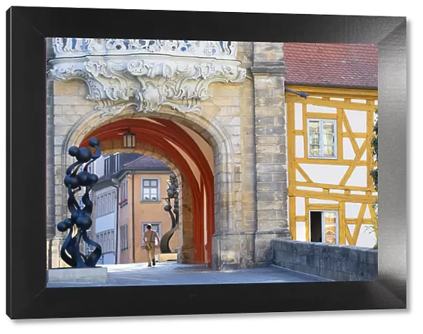 Man walking under Altes Rathaus (Old Town Hall), Bamberg (UNESCO World Heritage Site)