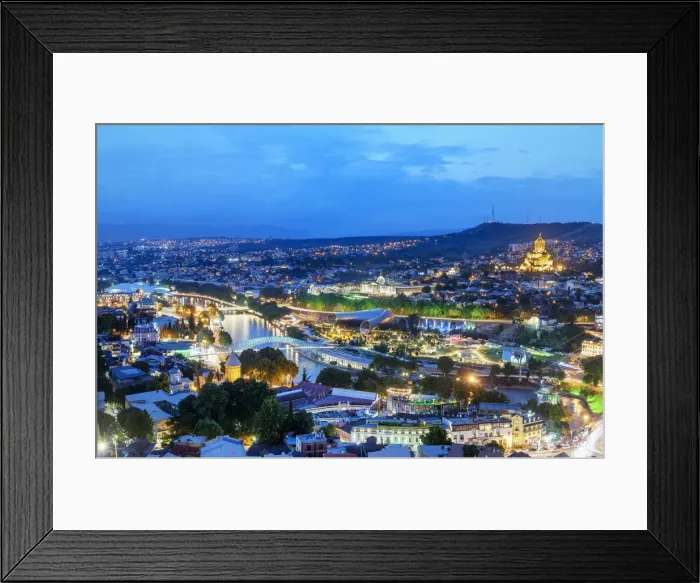 Framed Print : Tbilisi and the Mtkvari river at dusk. On the right the Holy Trinity Cathedral (Tsminda Framed Print : Tbilisi and the Mtkvari river at dusk. On the right the Holy Trinity Cathedral (Tsminda