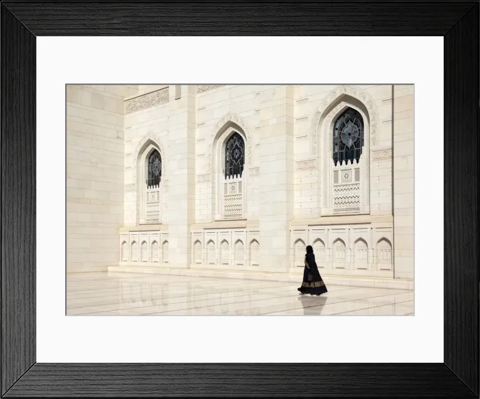 Framed Print : An Omani woman walks past the marble facade of Sultan Qaboos Grand Mosque, Muscat, Oman Framed Print : An Omani woman walks past the marble facade of Sultan Qaboos Grand Mosque, Muscat, Oman