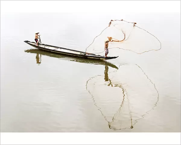 Net casting fishermen on the Perfume River, Hue, Vietnam