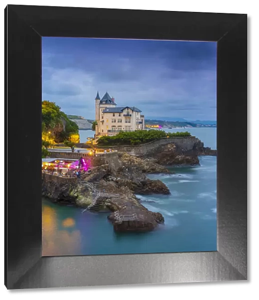 France, Aquitaine, Pyrenees Atlantiques, Biarritz. Old mansion on the cliffs at dusk