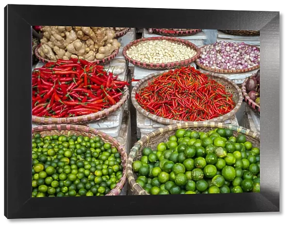 Chili peppers, limes and garlic for sale at Đồng Xuan