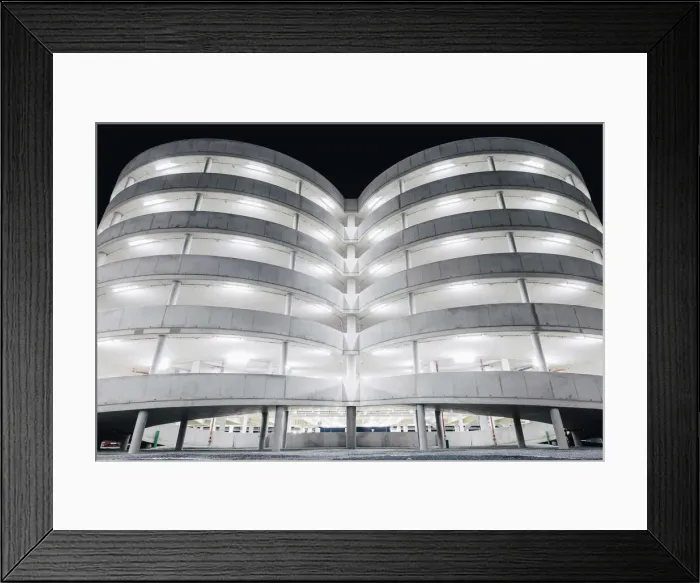 Framed Print : Illuminated parking garage concrete structure at night, Hamburg, Germany