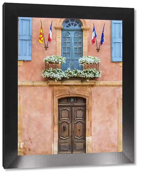 Colorful ochre colored faAzade of Mairie (mayors office) in Roussillon, Vaucluse