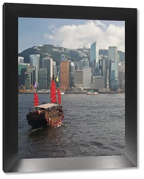 One of the last remaining Chinese sailing junks on Victoria Harbour, Hong Kong, China, Asia, viewed from Kowloon, Central skyine beyond