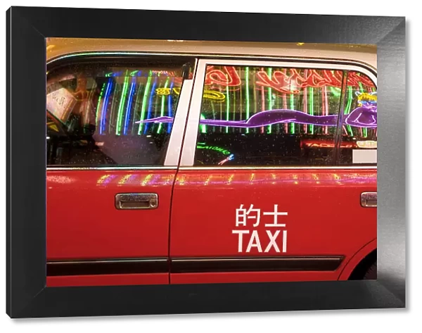 China, Hong Kong, Wan Chai, nightlife neon reflected in a Hong Kong taxi window
