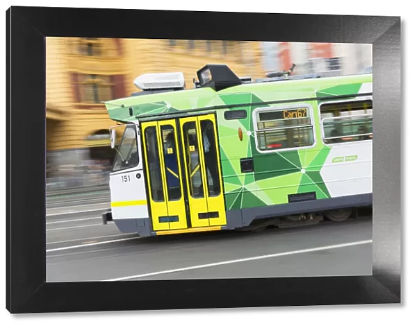 Tram passing Flinders Street Station, Melbourne, Victoria, Australia