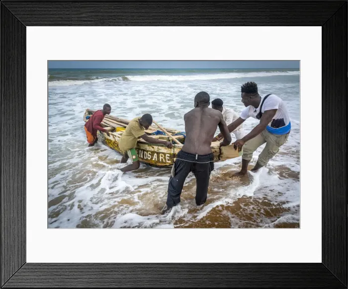 Framed Print : Africa, Benin, Grand Popo. A group of fishermen taking their boat into the water Framed Print : Africa, Benin, Grand Popo. A group of fishermen taking their boat into the water
