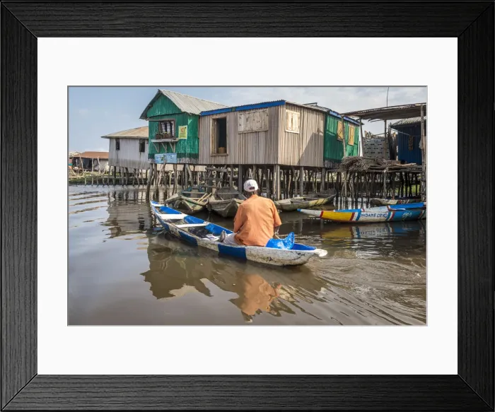 Framed Print : Africa, Benin, Ganvie. A man in his canoe passing by a shop in the floating village Framed Print : Africa, Benin, Ganvie. A man in his canoe passing by a shop in the floating village
