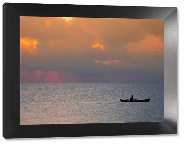 Central America, Belize, Ambergris Caye, San Pedro, a fisherman in front of stormy