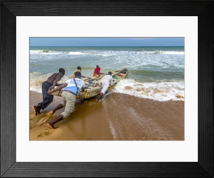 Framed Print : Africa, Benin, Grand Popo. A group of fishermen taking their boat into the water Framed Print : Africa, Benin, Grand Popo. A group of fishermen taking their boat into the water