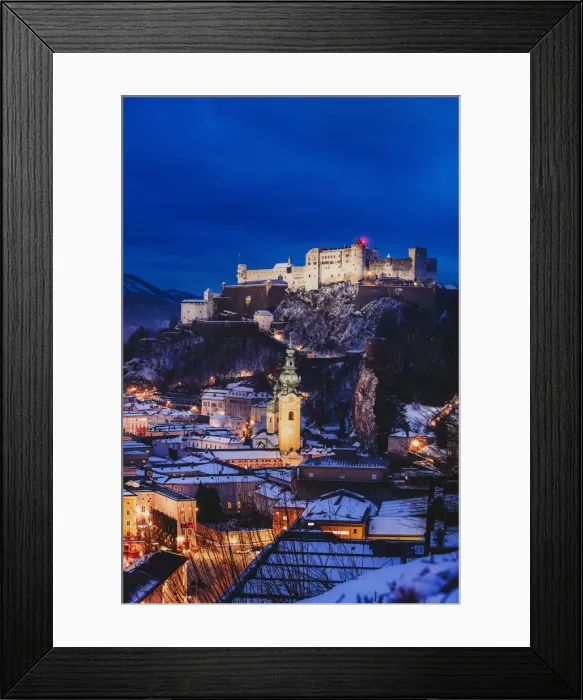 Framed Print : Elevated view of Salzburg city by night on a winter evening with the roofs covered Framed Print : Elevated view of Salzburg city by night on a winter evening with the roofs covered