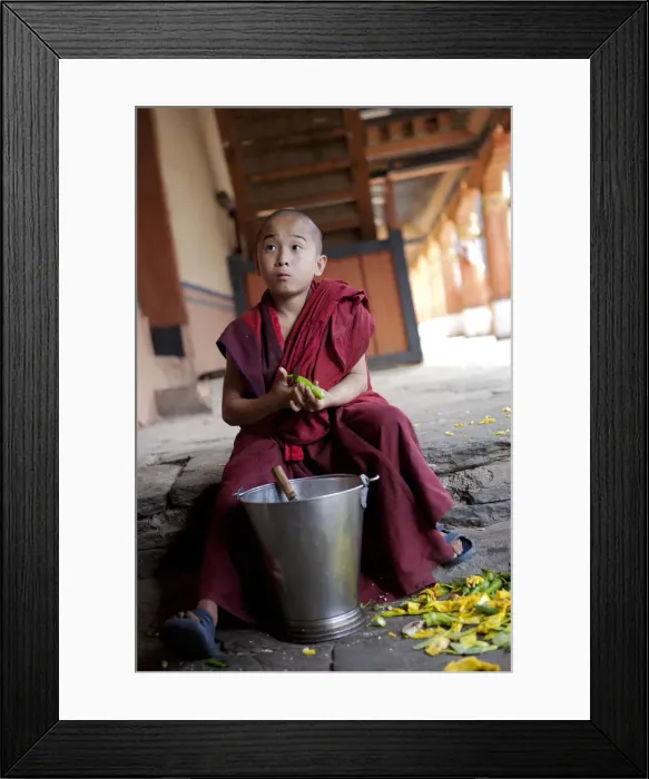 Framed Print : A young boy peeling vegetables in the dzong or monastery in Paro, Bhutan Framed Print : A young boy peeling vegetables in the dzong or monastery in Paro, Bhutan