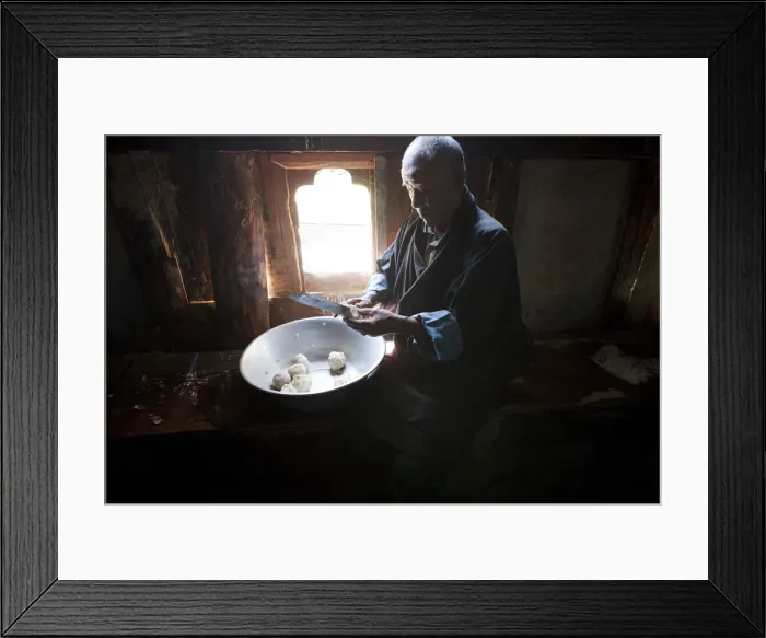 Framed Print : A man preparing potatos in the manufacture of arra in Ura in the Bumthang, Valley Framed Print : A man preparing potatos in the manufacture of arra in Ura in the Bumthang, Valley