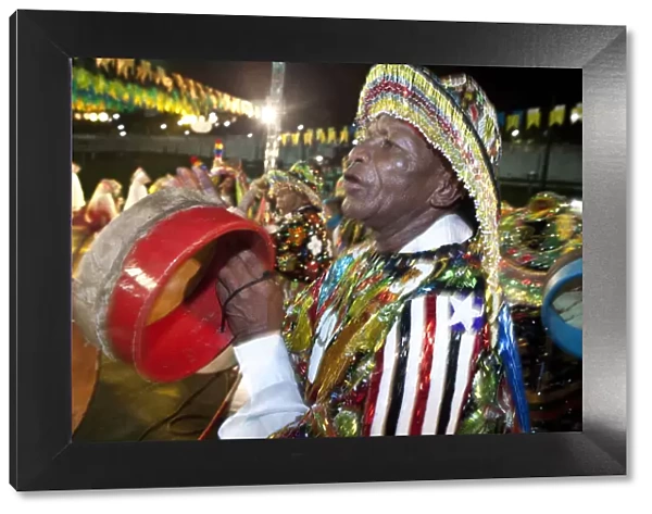South America, Brazil, Maranhao, Sao Luis, a costumed dancer with tamborim drum instrument