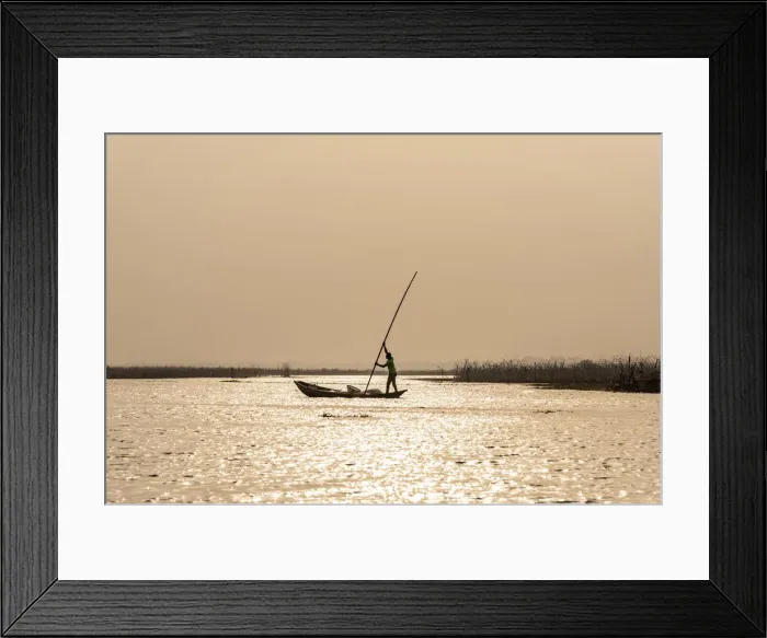 Framed Print : Africa, Benin, Lake Nokoua. A fisherman in his typical wooden canoe near to
