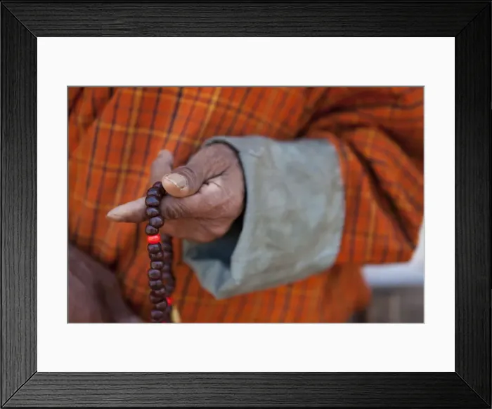 Framed Print : Wangdue, Bhutan. A man in a Gho with a closeup of Bhuddist prayer beads Framed Print : Wangdue, Bhutan. A man in a Gho with a closeup of Bhuddist prayer beads