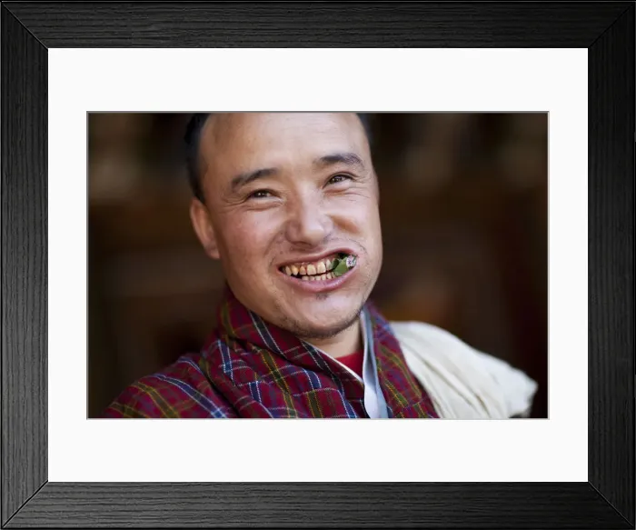 Framed Print : A Bhutanese man in a Gho eating Betel nut in Bhutan