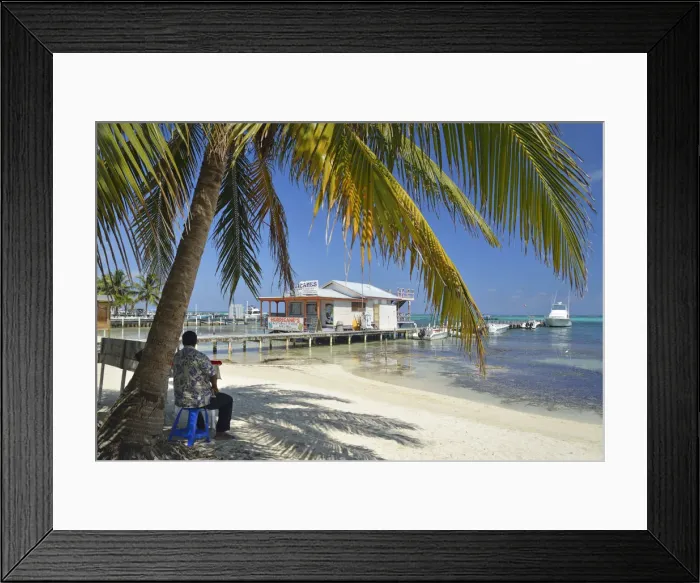 Framed Print : Man sat under a palm on the beach at San Pedro, Ambergris Caye, Caribbean, Central Framed Print : Man sat under a palm on the beach at San Pedro, Ambergris Caye, Caribbean, Central