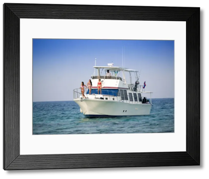 Framed Print : Central America, Belize, models on a motor yacht on the cayes