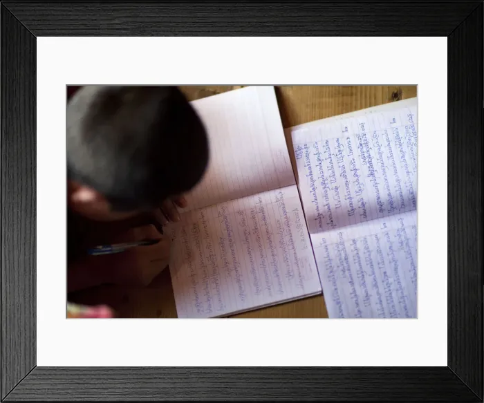 Framed Print : A young monk studying and writing sanskrit at the monastery in Thimpu Bhutan Framed Print : A young monk studying and writing sanskrit at the monastery in Thimpu Bhutan