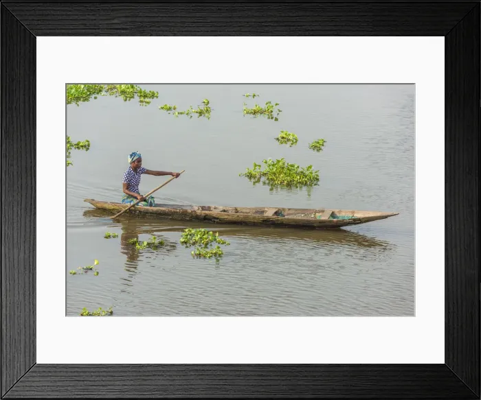 Framed Print : Africa, Benin, Lake Nokoua. A woman in her traditional wooden boat in the famous Framed Print : Africa, Benin, Lake Nokoua. A woman in her traditional wooden boat in the famous