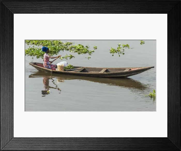 Framed Print : Africa, Benin, Lake Nokoua. A woman on the way to the market in the famous stilt