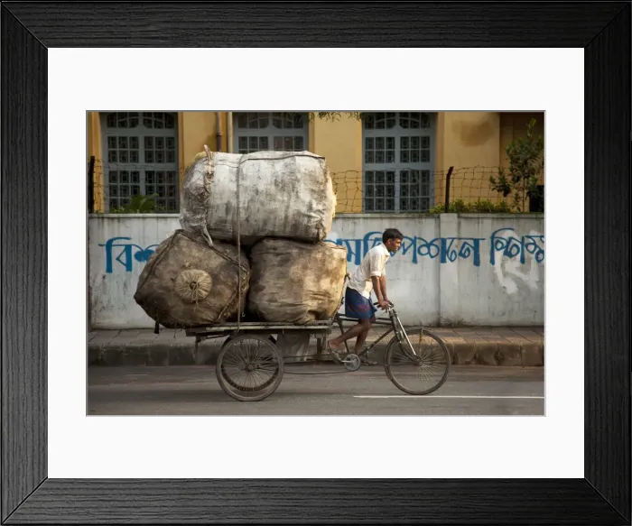 Framed Print : Dhaka, Bangladesh. A rickshaw rider transports goods around the capital Framed Print : Dhaka, Bangladesh. A rickshaw rider transports goods around the capital