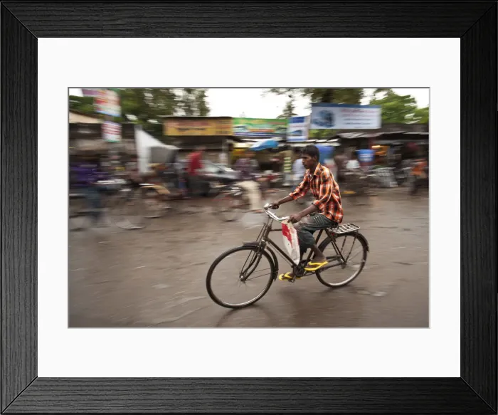 Framed Print : Jessore, Bangladesh. A man cycles to work through the centre of town Framed Print : Jessore, Bangladesh. A man cycles to work through the centre of town