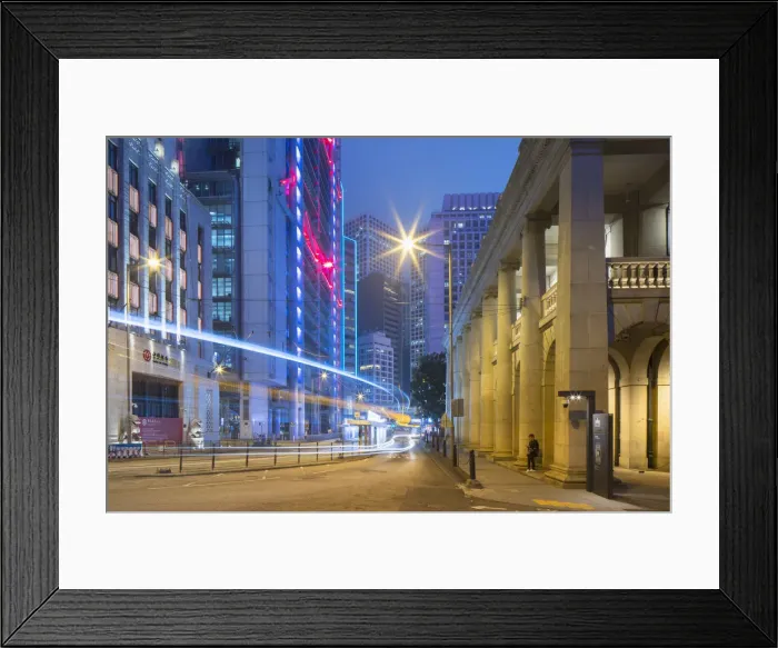Framed Print : Trams and traffic passing Bank of China Building and HSBC Building, Central, Hong Kong Framed Print : Trams and traffic passing Bank of China Building and HSBC Building, Central, Hong Kong