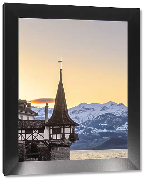 Sunrise at the castle of Oberhofen am Thunersee with the snow-covered Bernese Alps