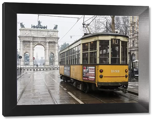 Iconic tramway with Arch of Peace in the background. Milan, Lombardy, Italy