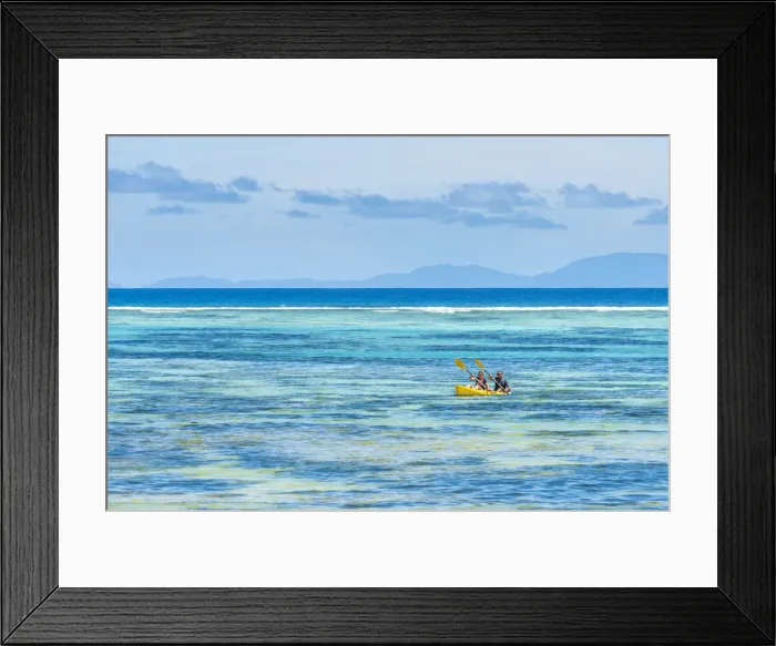 Framed Print : Tourists canoeing in la Digue, Seychelles, Africa Framed Print : Tourists canoeing in la Digue, Seychelles, Africa
