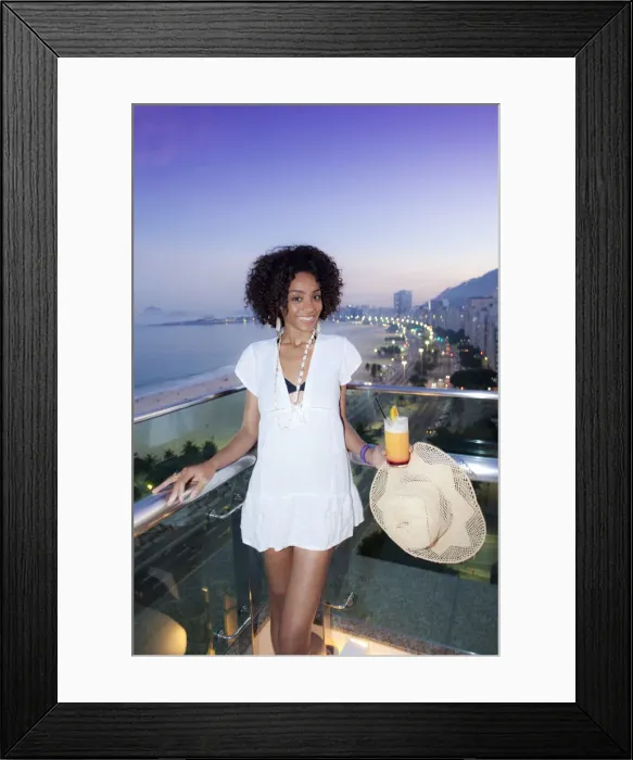 Framed Print : South America, Brazil, Rio de Janeiro, a model with a cocktail stands over Copacabana Framed Print : South America, Brazil, Rio de Janeiro, a model with a cocktail stands over Copacabana