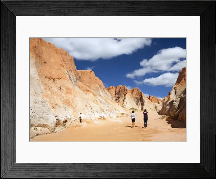 Framed Print : South America, Brazil, Ceara, Morro Branco, a tourist and a guide walk through a canyon Framed Print : South America, Brazil, Ceara, Morro Branco, a tourist and a guide walk through a canyon