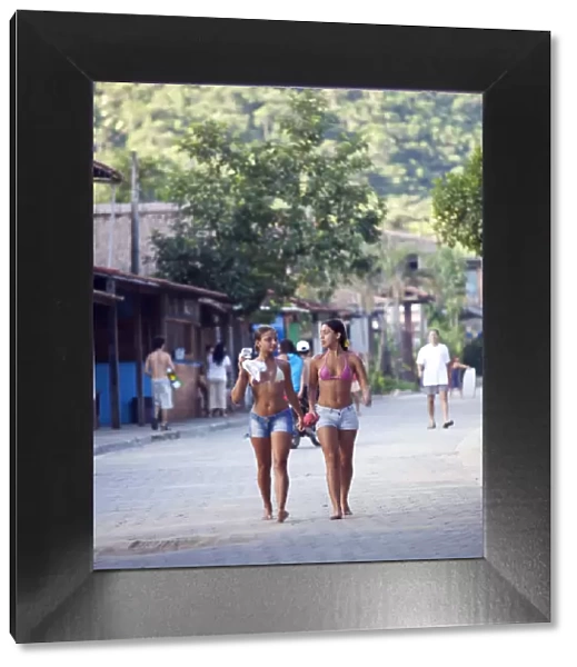 Brazil, Rio de Janeiro State, Costa Verde (Green coast), Paraty, two sufer girls walking