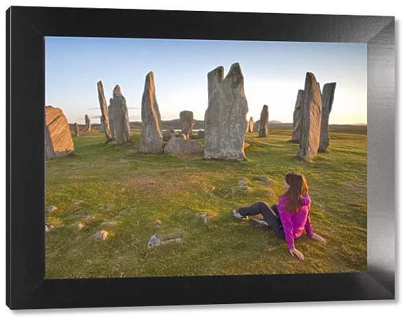 Woman staring at Neolithic stone circle, Callanish, Isle of Lewis, western scotland