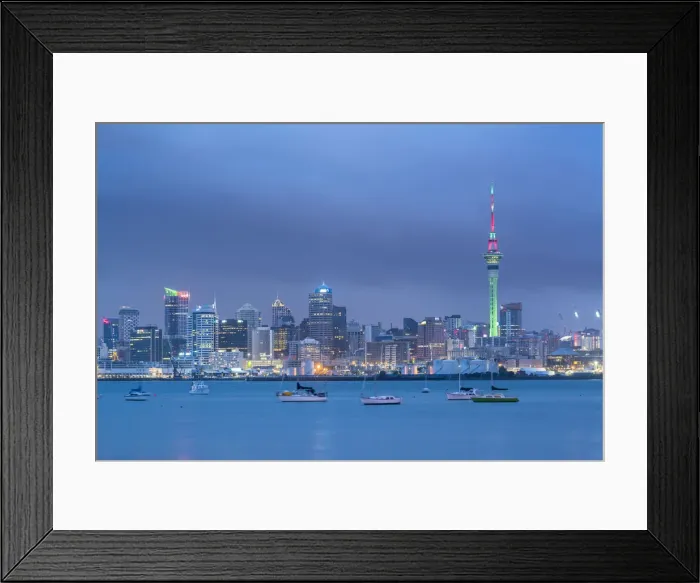 Framed Print : Skyline of Auckland Central Business District under a gloomy sky at dusk. Auckland City, Auckland region Framed Print : Skyline of Auckland Central Business District under a gloomy sky at dusk. Auckland City, Auckland region