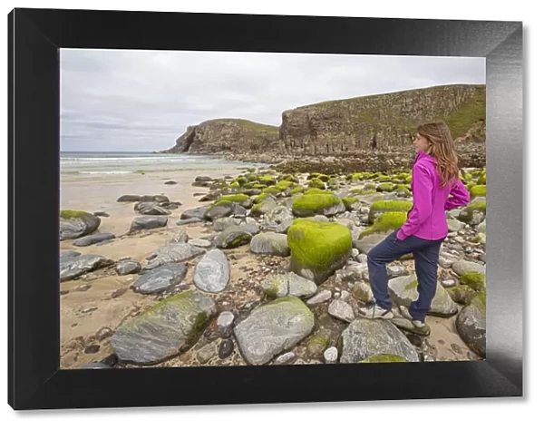 Woman staring at Dailbeag beach, Isle of Lewis, western scotland, United Kingdom