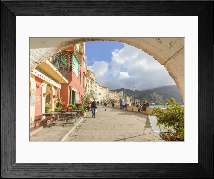 Framed Print : Tourists walking on the picturesque promenade of Camogli framed with an old arch