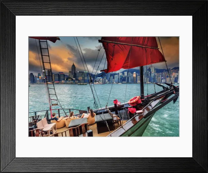 Framed Print : Hong Kong, tourist on a junk boat in Victoria harbor at sunset with Marina buildings Framed Print : Hong Kong, tourist on a junk boat in Victoria harbor at sunset with Marina buildings