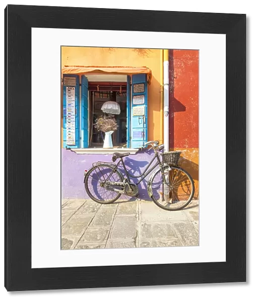 Colorful house facade in Burano island with old bike, Burano, Venice, Veneto, Italy