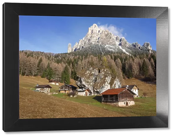 Alpine huts in Fosne, Primiero valley, Dolomites, Italy. Cimerlo mount in the background