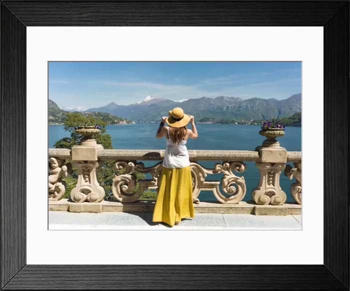 Framed Print : Tourist admiring Como lake view from the balcony of villa del Balbianello on punta Framed Print : Tourist admiring Como lake view from the balcony of villa del Balbianello on punta