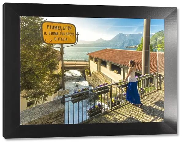 Woman admiring the short Fiumelatte river, Lake Como, Varenna, lecco Province, Lombardy