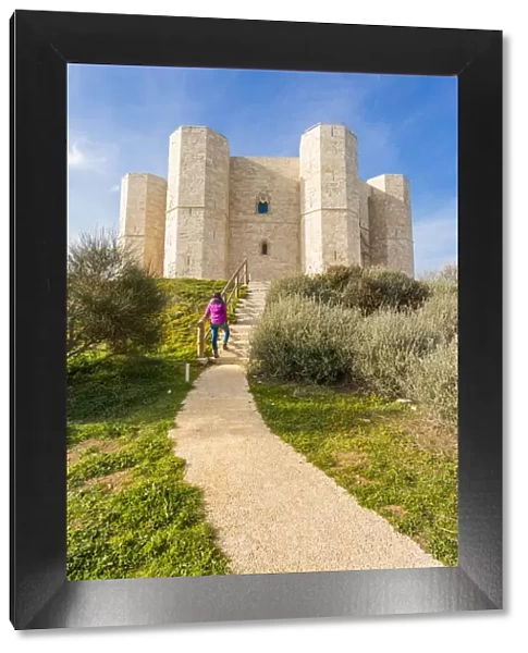 Tourist admiring Castel del Monte fortress in Andria, Apulia region, Italy (MR)